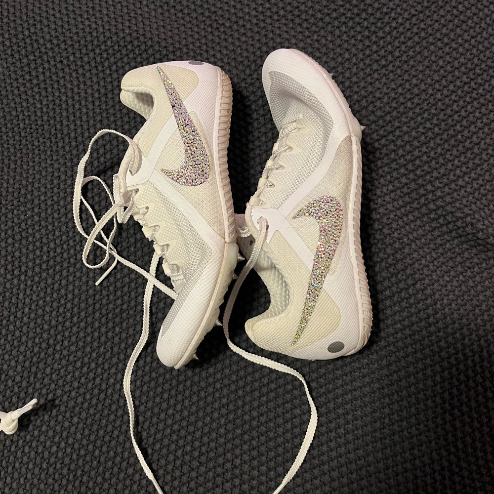 White nike track spikes with bedazzled swoosh